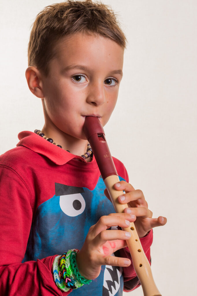 child playing recorder: 16 Homeschooling Tips for Including music education in your homeschool 