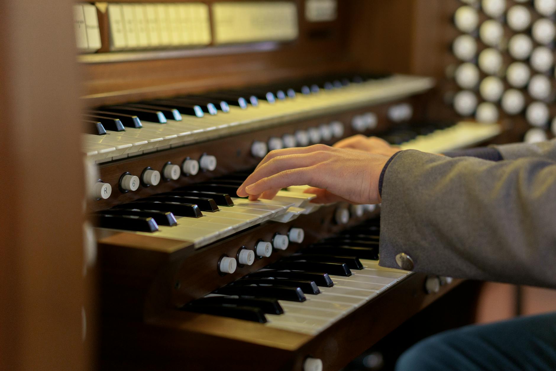 close up shot of a person playing organ, Hans Zimmer using unconventional instruments in movie music such as in Interstellar.