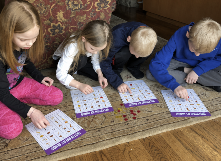 4 kids playing instrument bingo